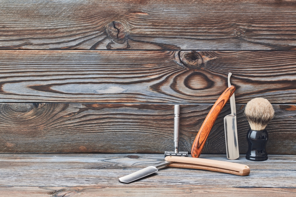 Vintage barber shop tools on wooden background. Vintage barber shop tools on old wooden background with copy space
