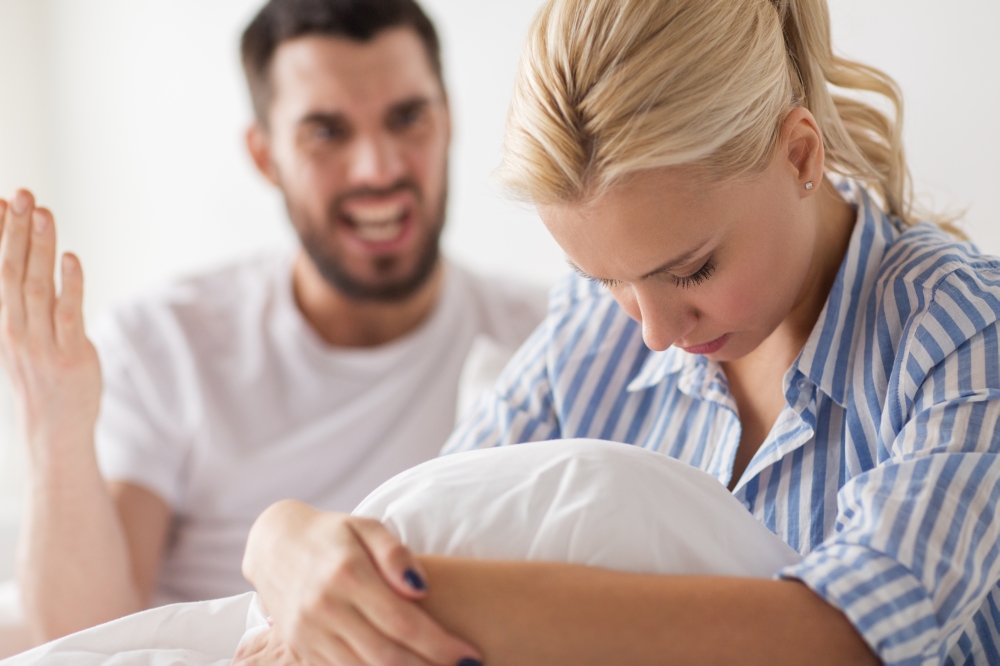 people, relationship difficulties, conflict and family concept - unhappy couple having quarrel in bed at home. unhappy couple having conflict in bed at home