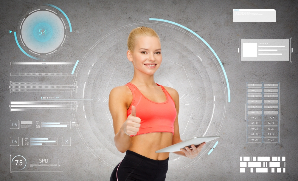 sport, fitness and technology - happy sporty woman with tablet pc computer showing thumbs up over gray concrete background. sporty woman with tablet pc showing thumbs up