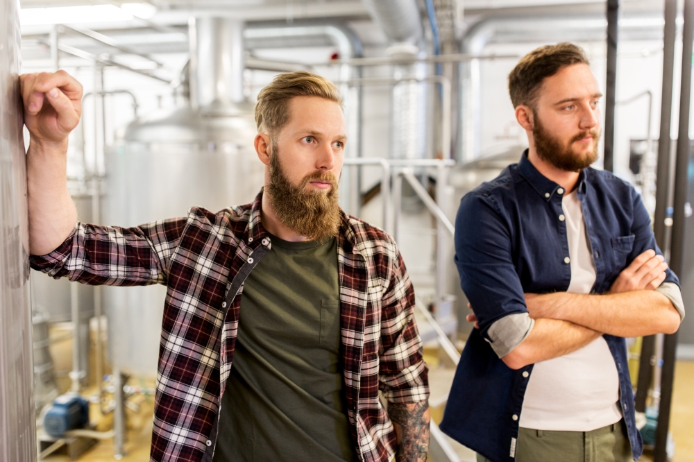manufacture, business and people concept - men at craft brewery or beer plant. men at craft brewery or beer plant. men at craft brewery or beer plant