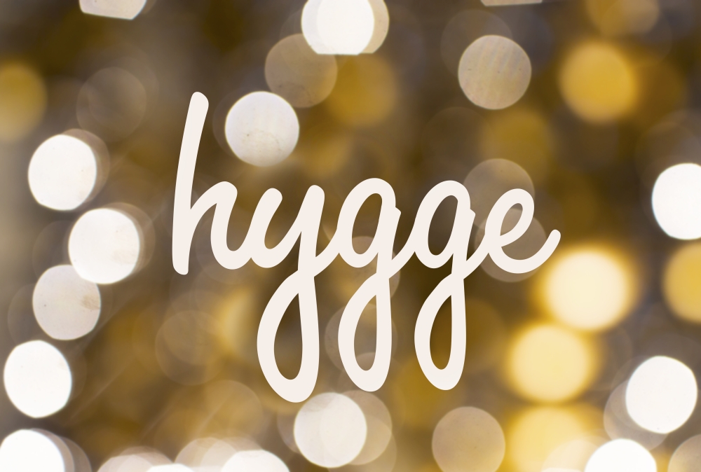 holidays and cosiness concept - word hygge over blurred golden lights background. word hygge over blurred golden lights background. word hygge over blurred golden lights background
