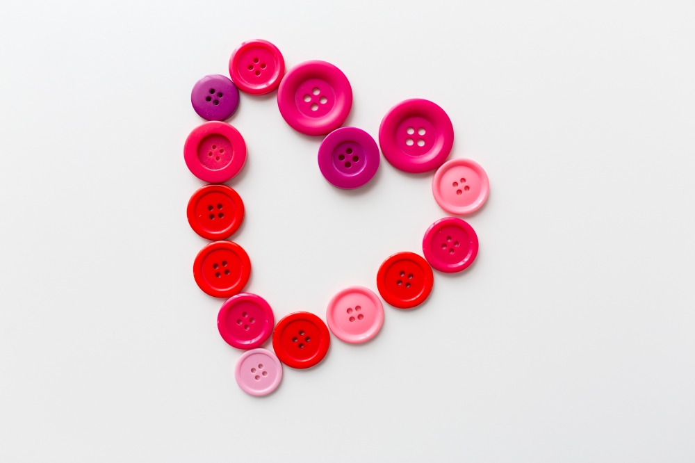 love, valentines day, needlework and tailoring concept - heart shape of sewing buttons. heart shape of sewing buttons. heart shape of sewing buttons