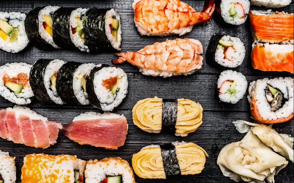 Variety of sushi: maki, nigiri,rolls  on dark wooden background, top view