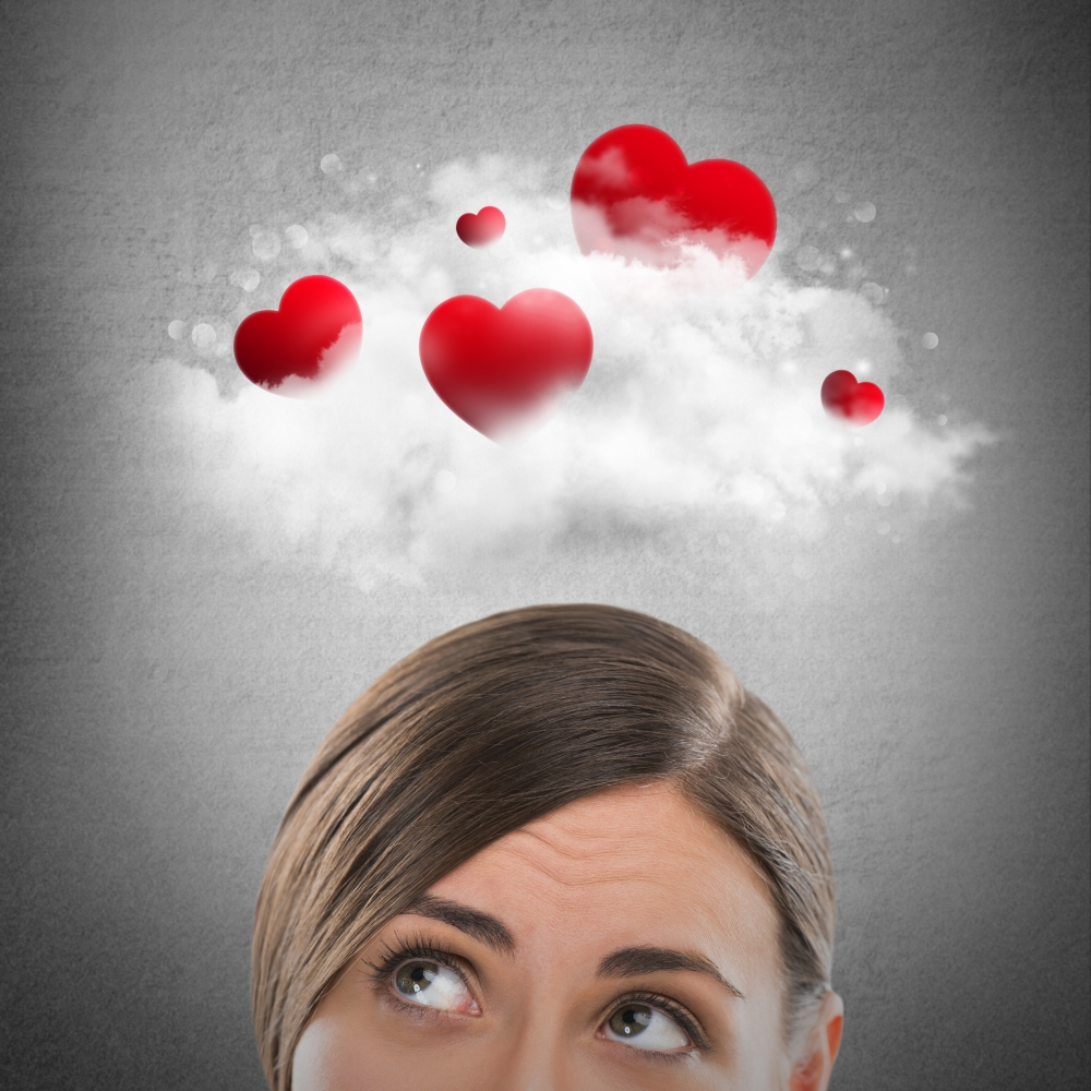 Red hearts flying in cloud overhead of beautiful dreamy woman. Valentine's day background