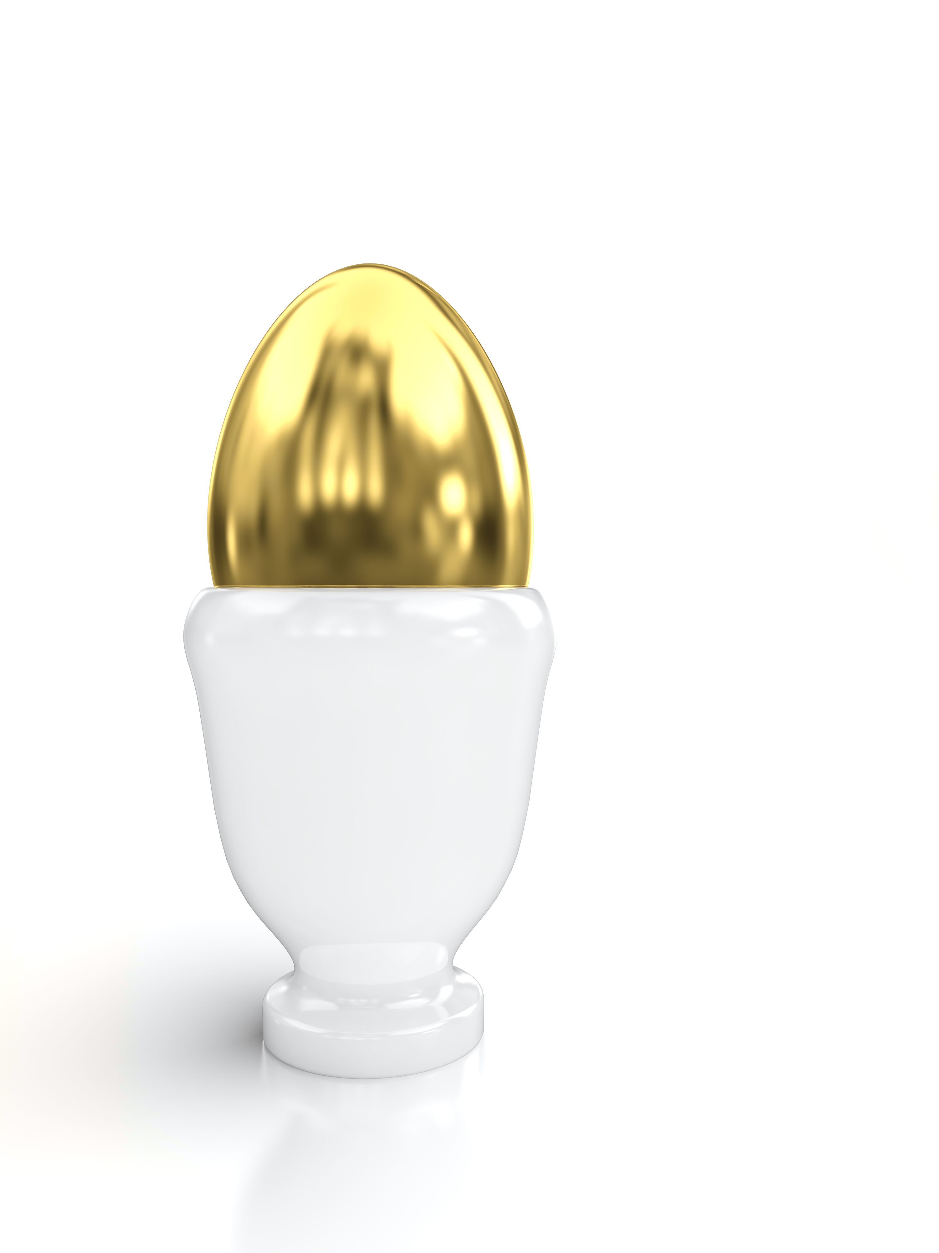 Golden egg in egg cup isolated on white background.