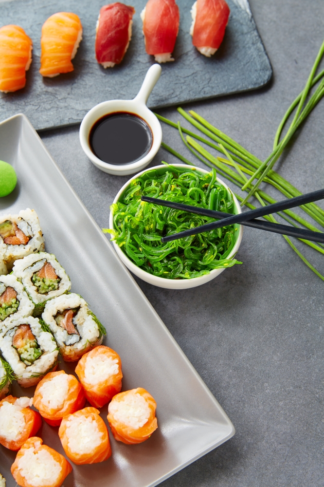 Sushi Maki and Niguiri California roll with seaweed chuka salad soy sauce and wasabi