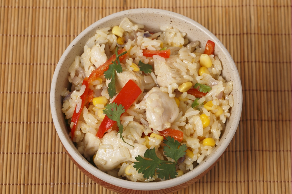 Chicken fried rice, containing capsicum, rice, garlic, egg, in a bowl from above
