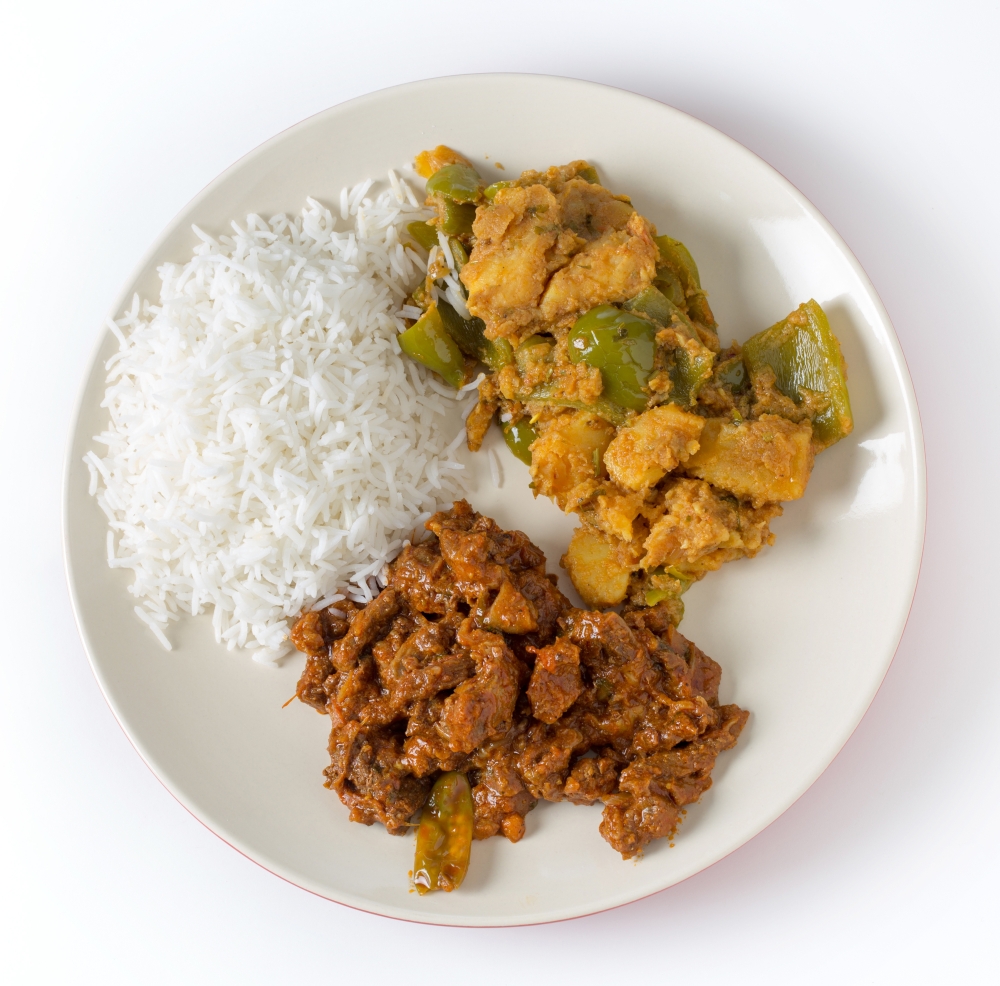 Indian roast beef curry with aloo capsicum, potato and bell pepper curry, and white rice.