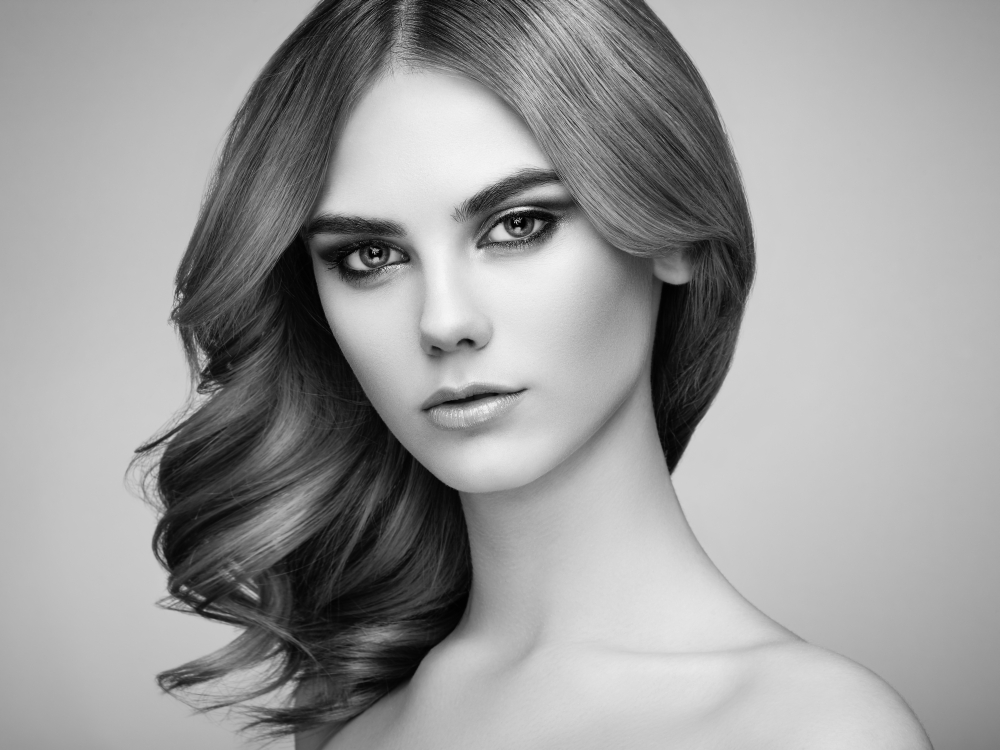 Portrait of beautiful sensual woman with elegant hairstyle. Perfect makeup. Beauty fashion. Eyelashes. Lips. Cosmetic Eyeshadow. Black and White