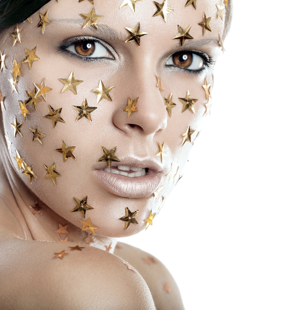 Headshot of a pretty woman with stars on face on a white background