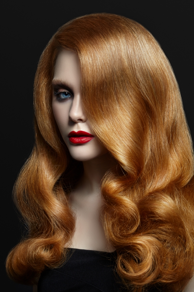 Woman with red hair on black background