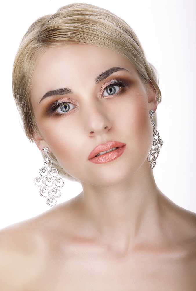 Magnetism. Portrait of Young Blond with Glossy Earrings