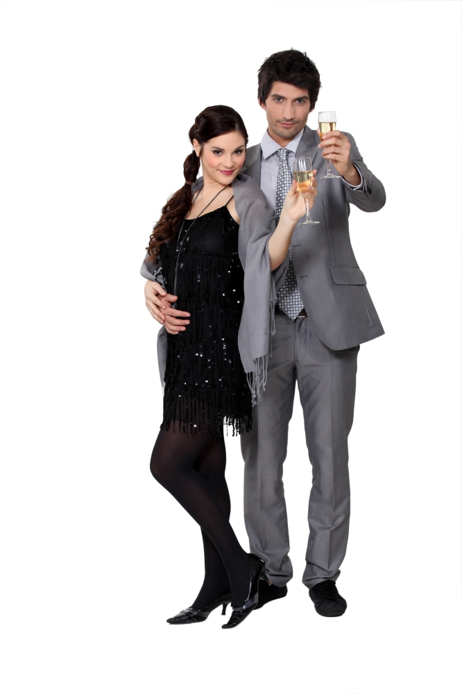 Smart couple holding champagne glasses