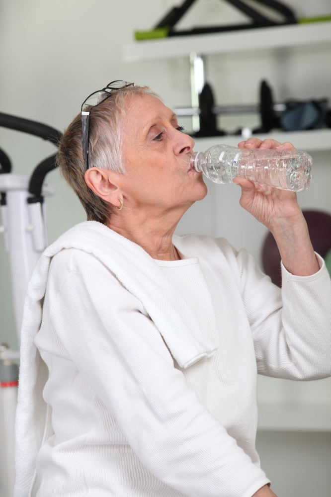 Woman in the gym drinking water