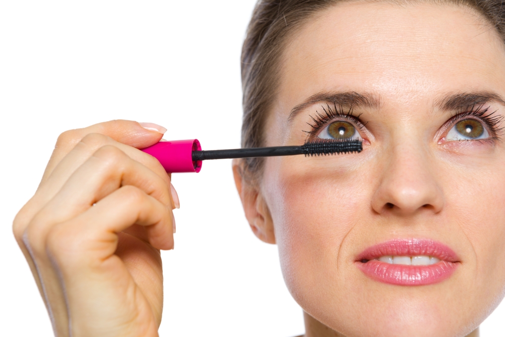Closeup on woman applying mascara