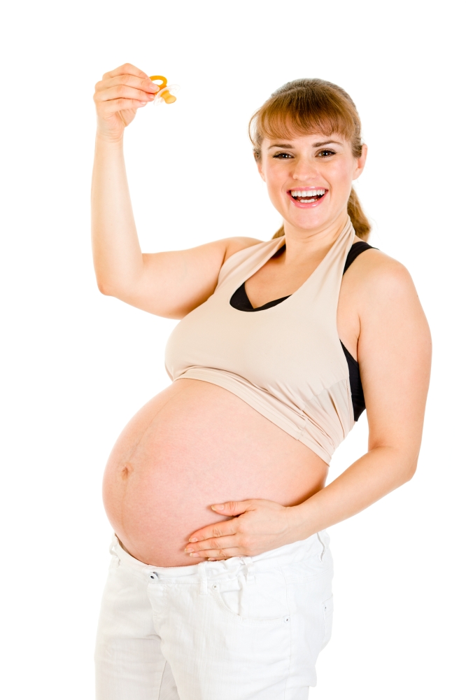 Smiling pregnant woman holding  baby dummy &#xA;