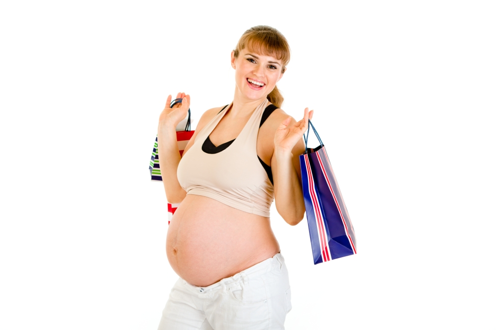 Beautiful pregnant woman holding shopping bags in hands isolated on white&#xA;