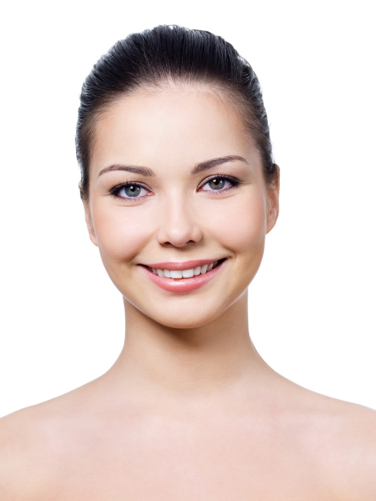 Beautiful smiling face of young woman with healthy clean skin - isolated