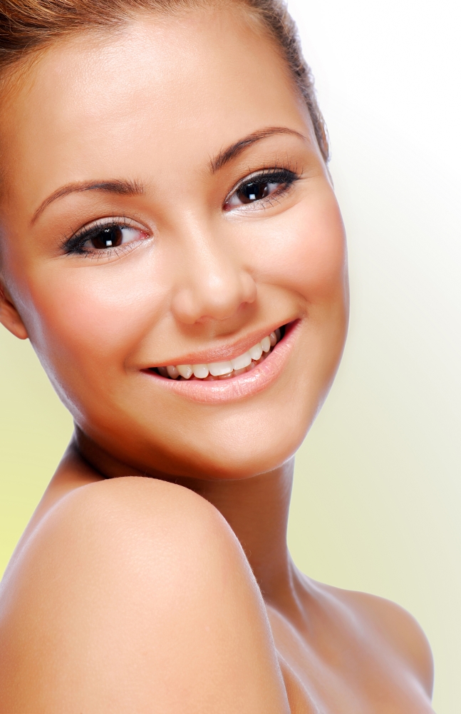 Close-up smiling face of young adult beautiful woman