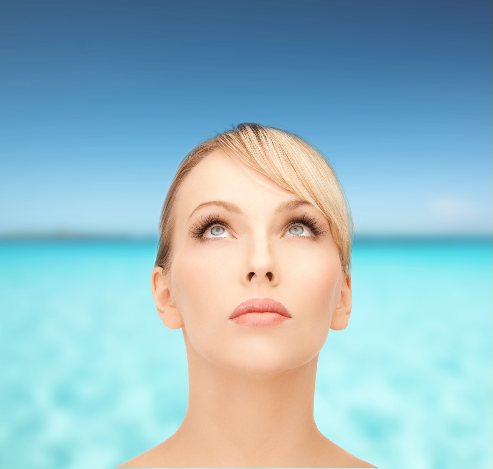 health, spa, beauty and vacation concept - beautiful woman with blonde hair looking up