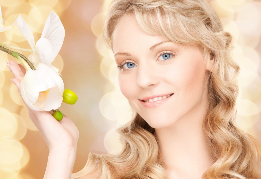 beauty and people concept - face of beautiful young woman over beige lights background