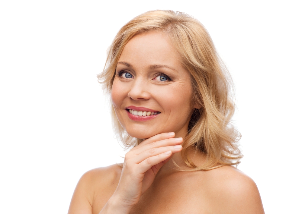beauty, people and skincare concept - smiling woman with bare shoulders touching face