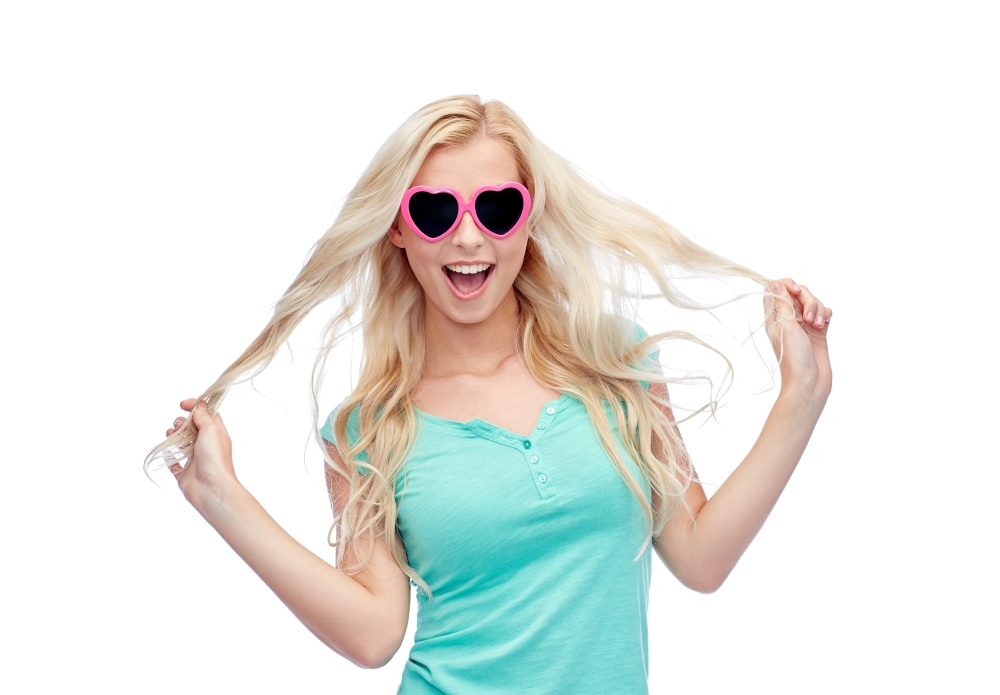 emotions, expressions, summer and people concept - smiling young woman or teenage girl in sunglasses holding her strand of hair