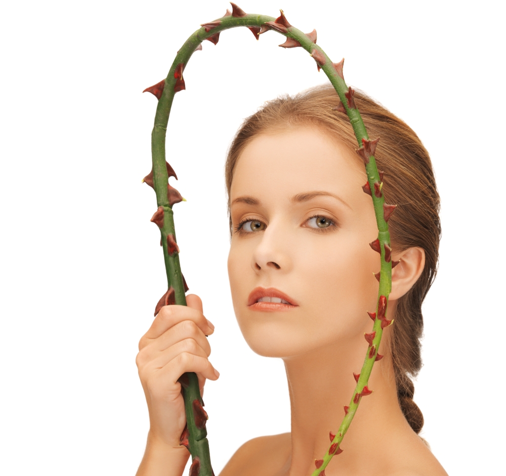 picture of lovely woman holding branch with thorns.