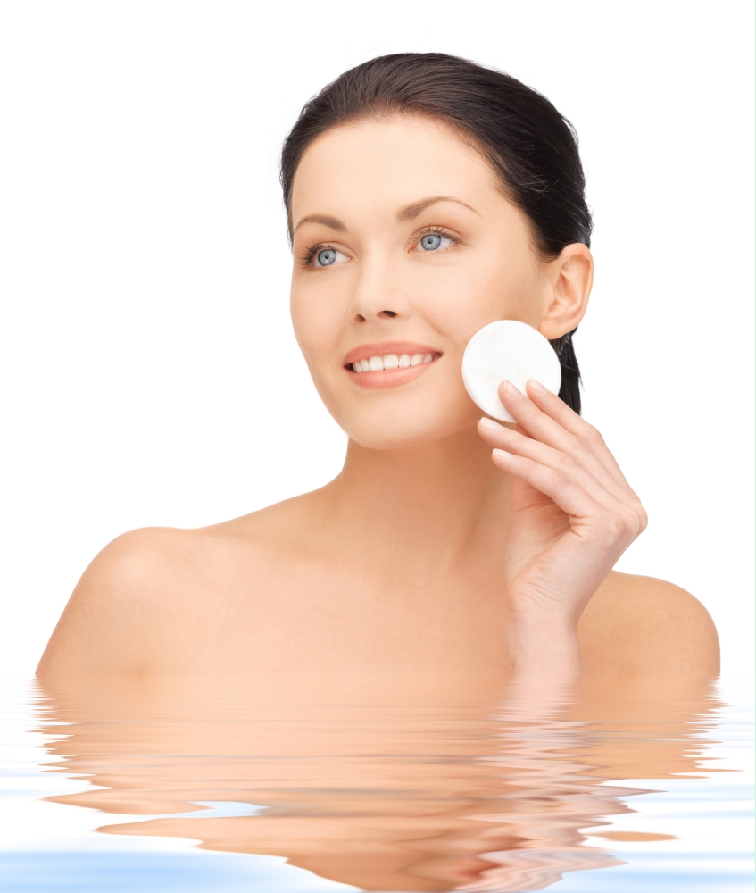 bright picture of beautiful woman with cotton pad in water