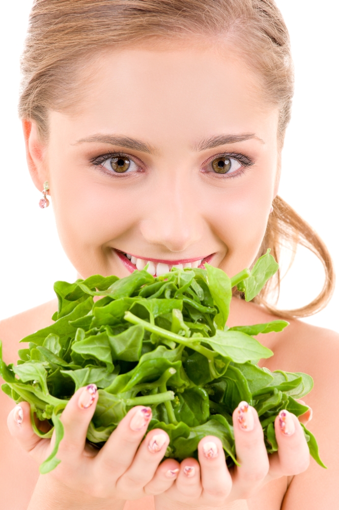 picture of happy woman with spinach over white