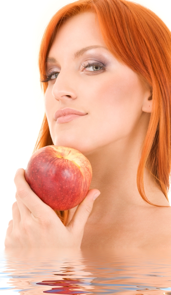 redhead woman with red apple over white