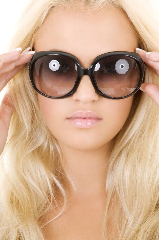 picture of blonde in big sunglasses over white