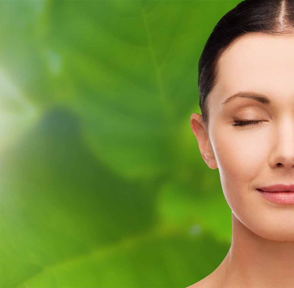 health, spa and beauty concept - clean face of beautiful young woman with closed eyes