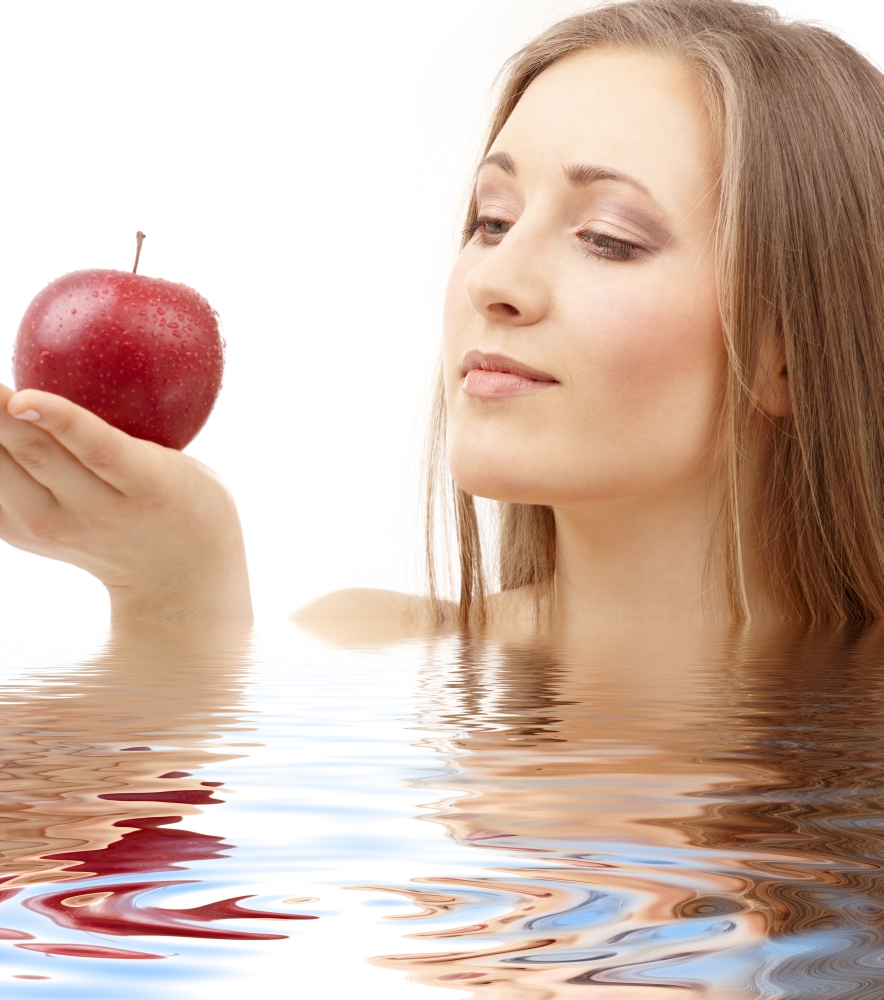 portrait of woman with red apple in water