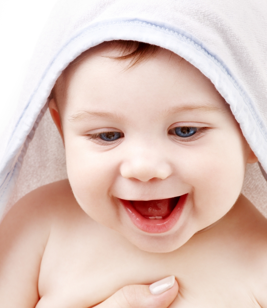 happy baby with terry hoodie robe on head over white