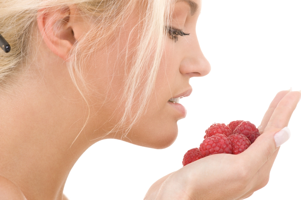 picture of lovely woman with raspberries over white