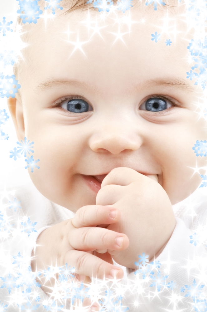 bright closeup portrait of adorable baby with snowflakes
