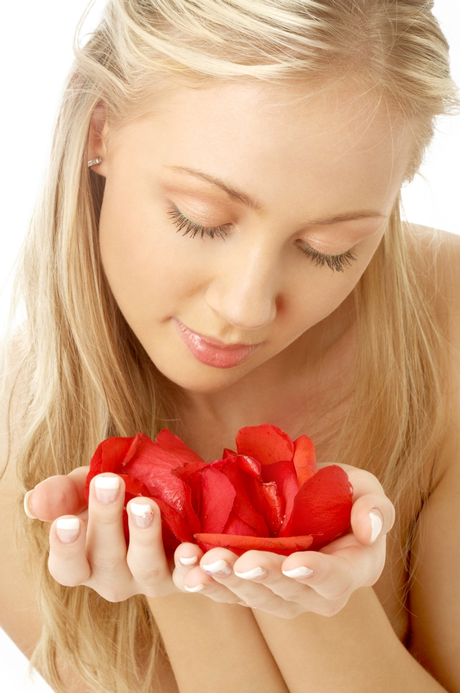 portrait of lovely blond in spa with red rose petals