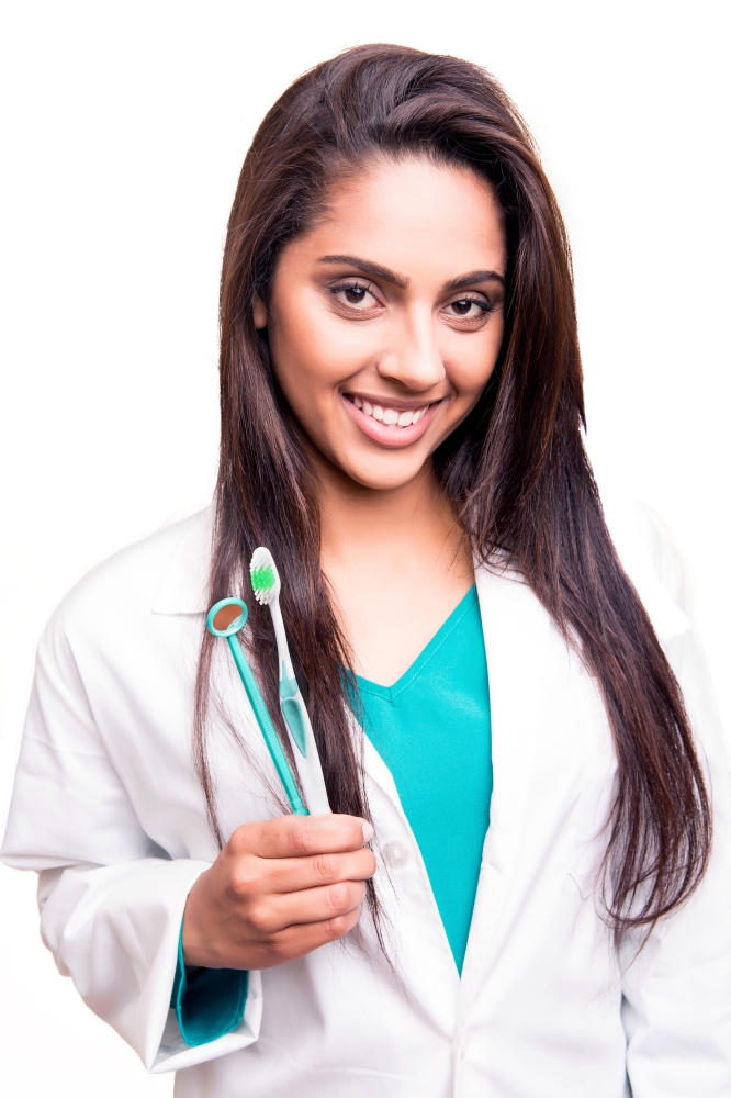 Female dentist doctor showing dental mirror and toothbrush