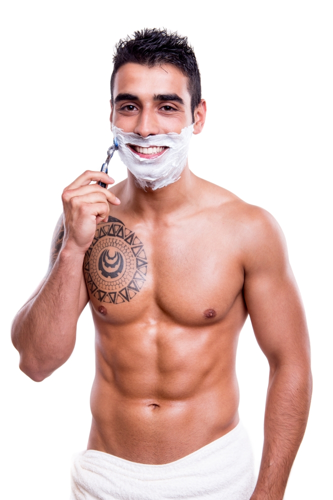 Man shaving his face over white background