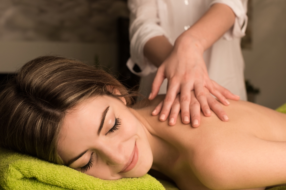 Young woman having a back massage at the spa