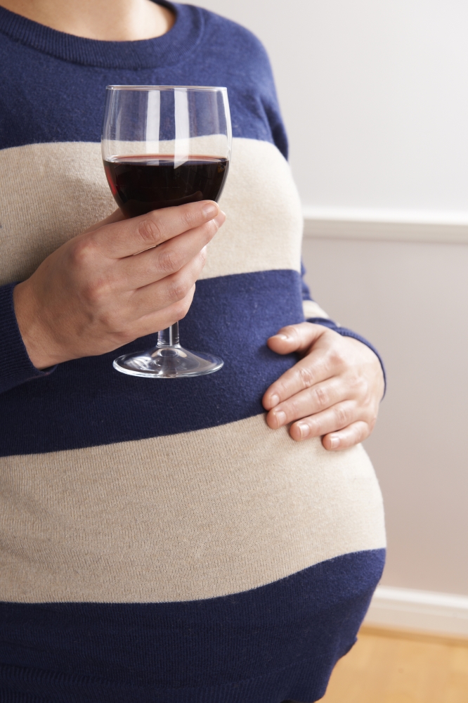Detail Of Pregnant Woman Drinking Glass Of Red Wine