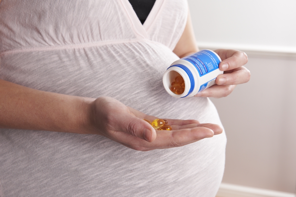 Detail Of Pregnant Woman Taking Vitamins