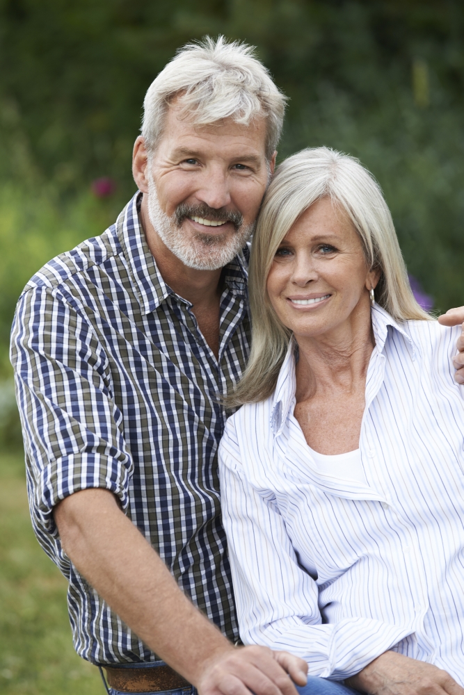 Portrait Of Mature Couple Relaxing In Garden Together