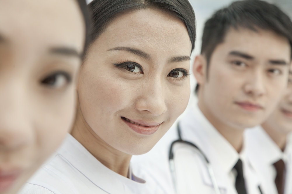 Healthcare workers standing in a row, China, Close-up