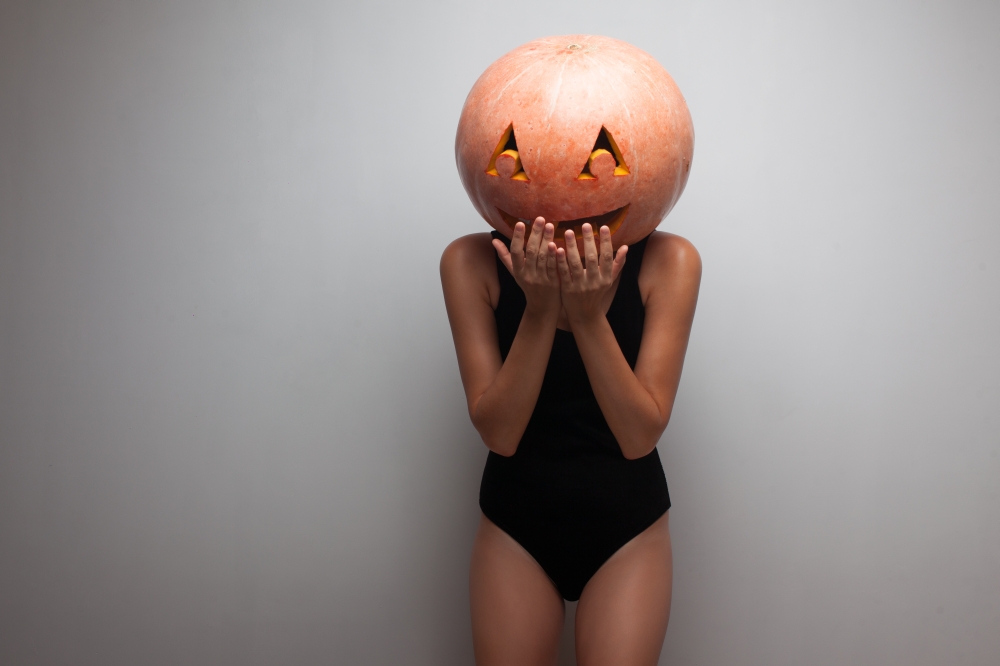 Funny pumpkin face. Dancer in Halloween costume.