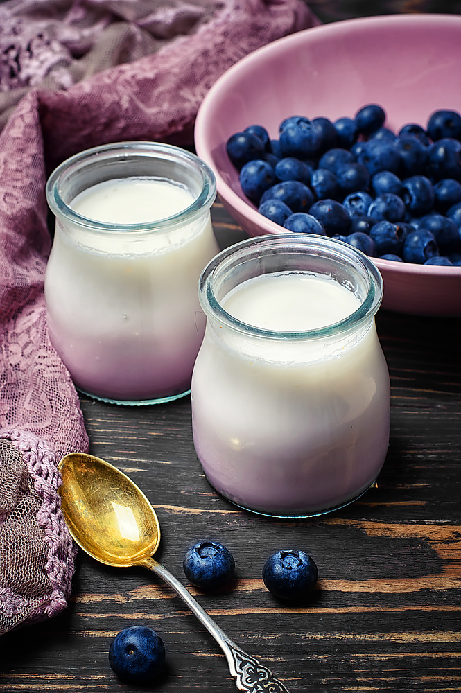 yogurt with blueberries. yogurt in glass jars of berries and fresh blueberry