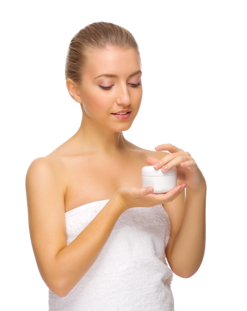Young girl with jar with body cream isolated