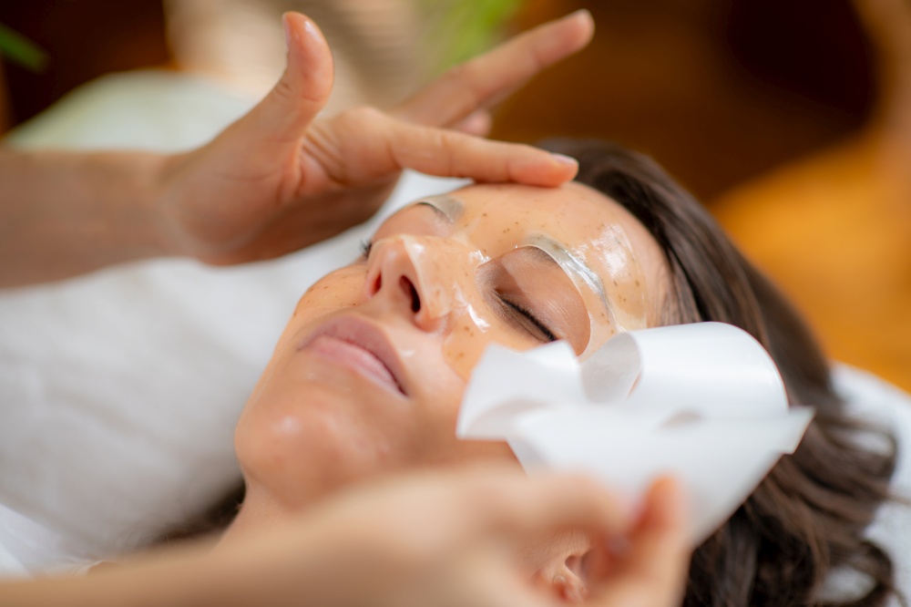 Woman indulges in a luxurious skincare treatment with a face mask at the beauty salon