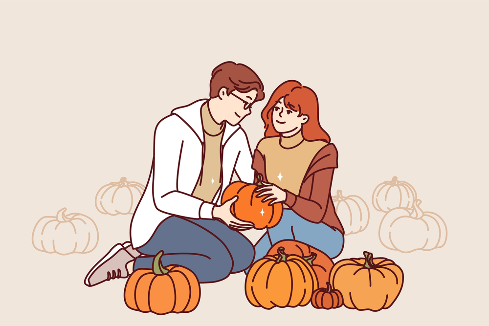 Couple of lovers holding pumpkin working together on farm growing organic vegetables and fruits. Man and woman in love smiling harvesting pumpkin for halloween or thanksgiving holiday. Couple of lovers holding pumpkin working together on farm growing organic vegetables and fruits